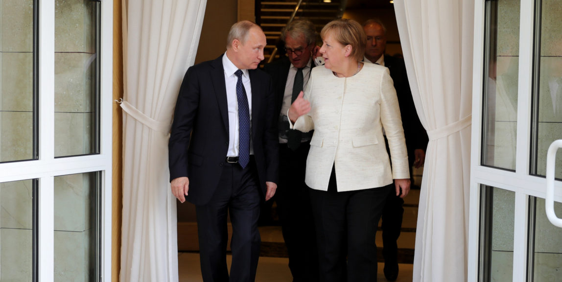 Russian President Vladimir Putin listens to German Chancellor Angela Merkel as they walk after a joint news conference at Putin's residence in the Russian Black Sea resort of Sochi, Russia, Friday, May 18, 2018. The meeting in Sochi is Merkel's first visit to Russia in a year and comes amid tense relations between Berlin and Moscow. (Mikhail Klimentyev, Sputnik, Kremlin Pool Photo via AP)