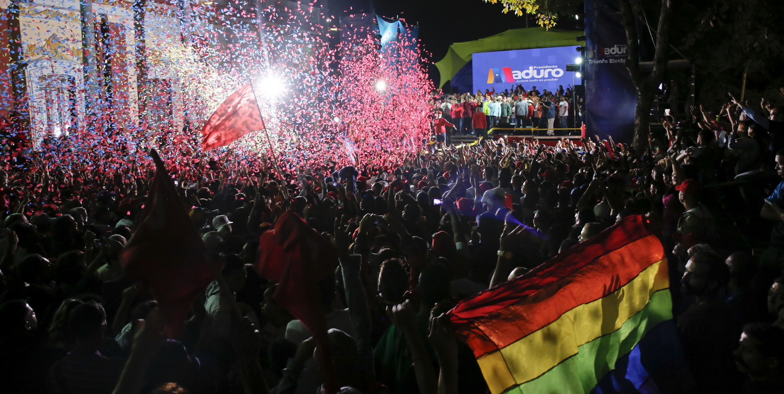 Supporters of Venezuela's President Nicolas Maduro gather at the presidential palace in Caracas, Venezuela, Sunday, May 20, 2018. Electoral officials declared the socialist leader the winner of Sunday's presidential election, while his leading challenger questioned the legitimacy of a vote marred by irregularities and called for a new ballot. (AP Photo/Ariana Cubillos)