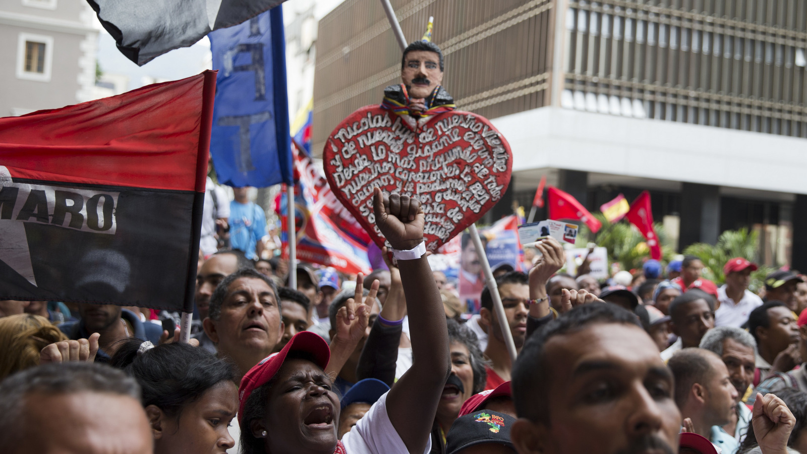 Supporters of Venezuela's President Nicolas Maduro gather outside the government-controlled National Electoral Council in Caracas, Venezuela, Tuesday, May 2, 2018. Maduro was officially declared winner of the presidential election. (AP Photo/Ricardo Mazalan)