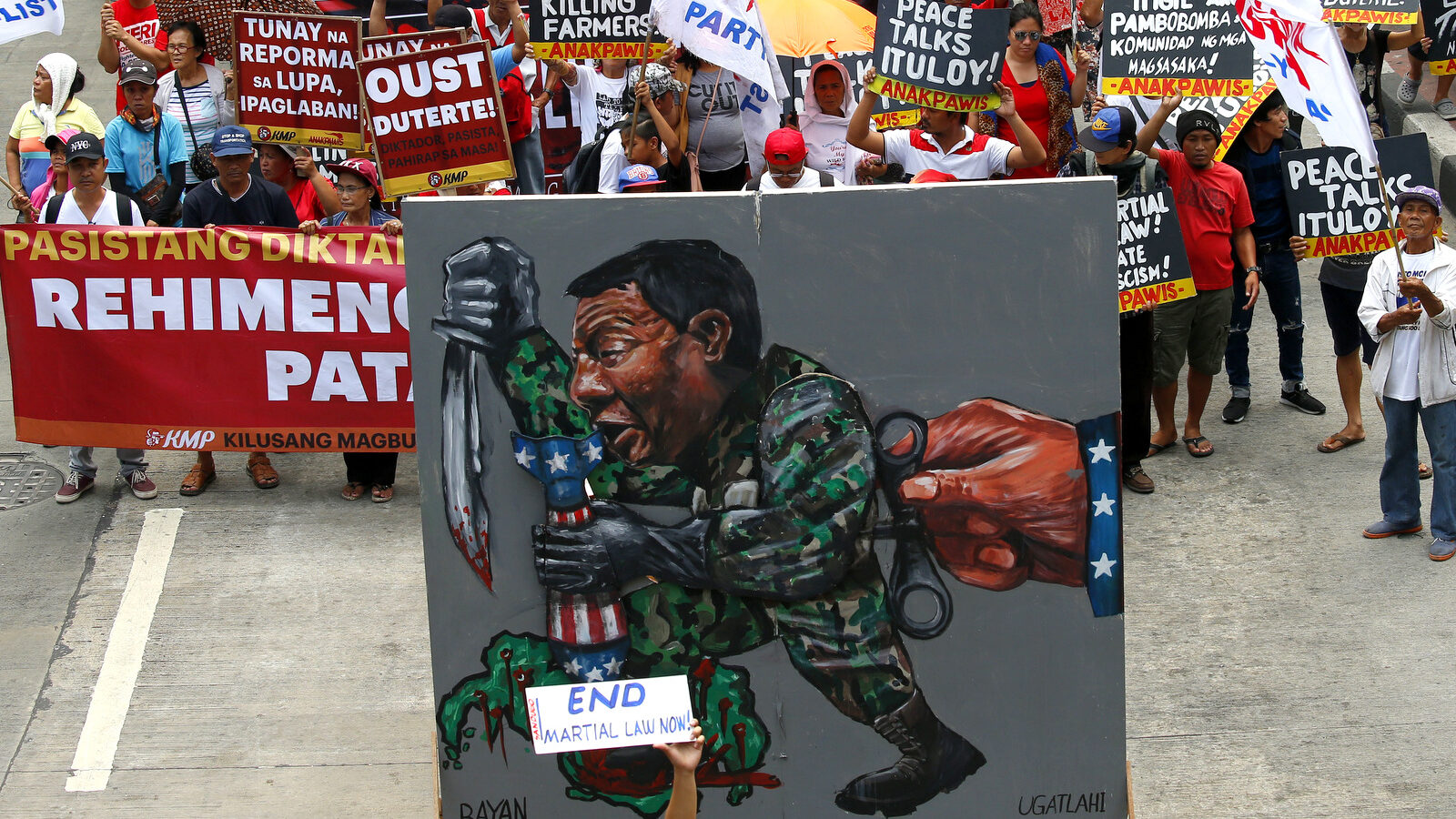 Protesters march towards the Presidential Palace with a huge mural depicting President Rodrigo Duterteas they mark the anniversary of the siege by Islamic State group-aligned militants of Marawi city in southern Philippines exactly a year ago Wednesday, May 23, 2018. The May 23 siege that troops crushed in October killed more than 1,100 mostly militants, left the mosque-studded city's heartland in rubbles, gave President Rodrigo Duterte's his most serious crisis and reinforced Asian fears that the Islamic State group has gained a foothold in the region. (AP Photo/Bullit Marquez)