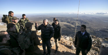 Israel's Prime Minister Benjamin Netanyahu, center, talks with Israeli soldiers at a military outpost during a visit at Mount Hermon in the Israeli-occupied Golan Heights overlooking the Israel-Syria border on, Feb. 4, 2015. Baz Ratner | AP