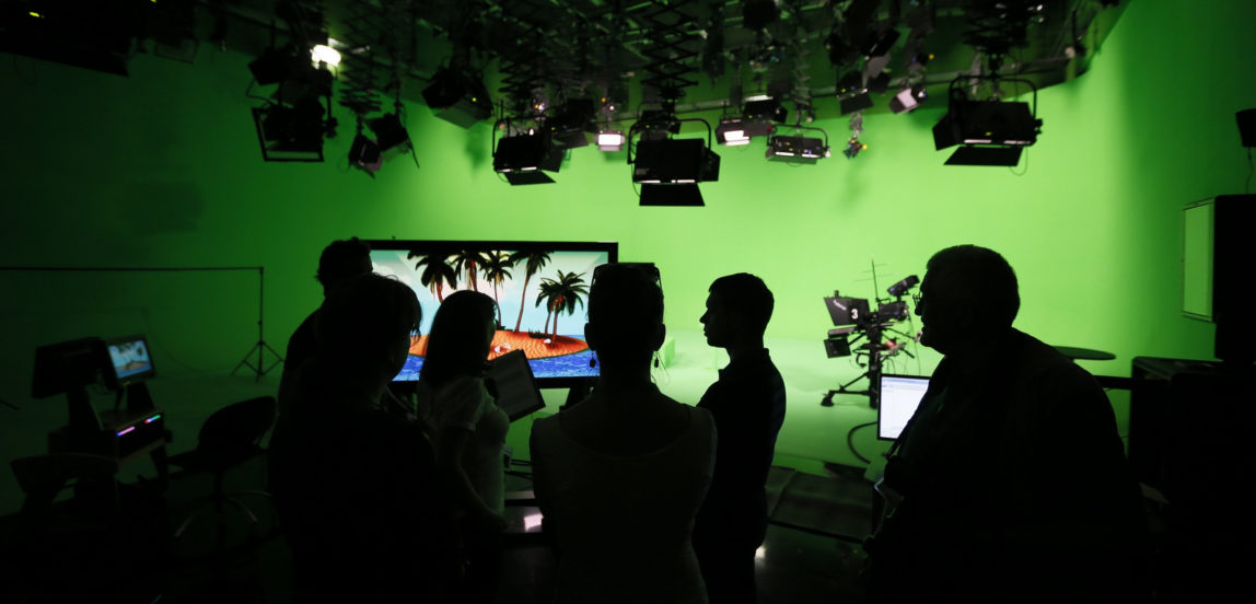 Employees of the "Russia Today" television channel prepare for a visit b Russian President Vladimir Putin to Russia Today's new headquarters in Moscow, Russia. (Yuri Kochetkov/via AP)