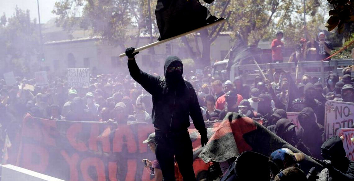 An anti-fascist demonstrator jumps over a barricade during a free speech rally Aug. 27 in Berkeley, Calif. (AP Photo)