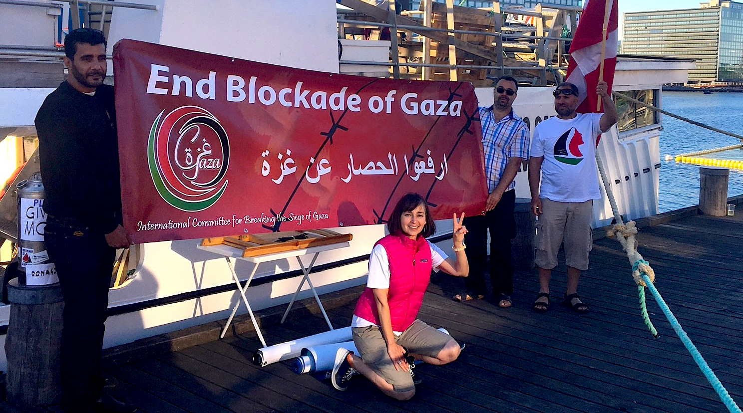 Elizabeth Murray poses in front of a the Al Awda, the ship she will be sailing in to Gaza. (Photo: Elizabeth Murray)