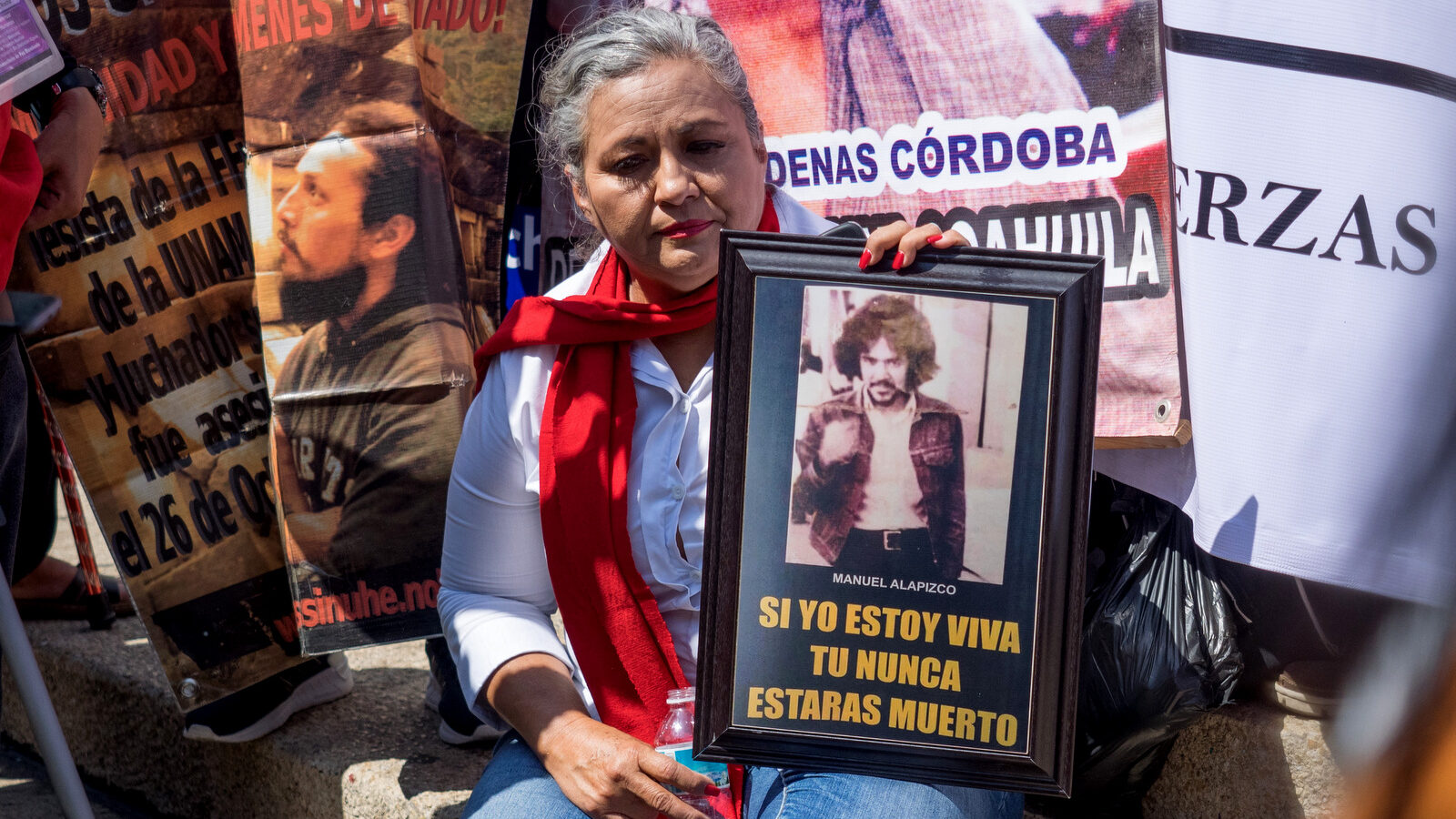 A woman holds an image of her husband who was detained and assassinated by the state during Mexico's dirty war against leftist social activists in the 1970's, the image reads 'As long as I'm alive, you will never be dead', Mexico City, May 10, 2018. (Photo: José Luis Granados Ceja)