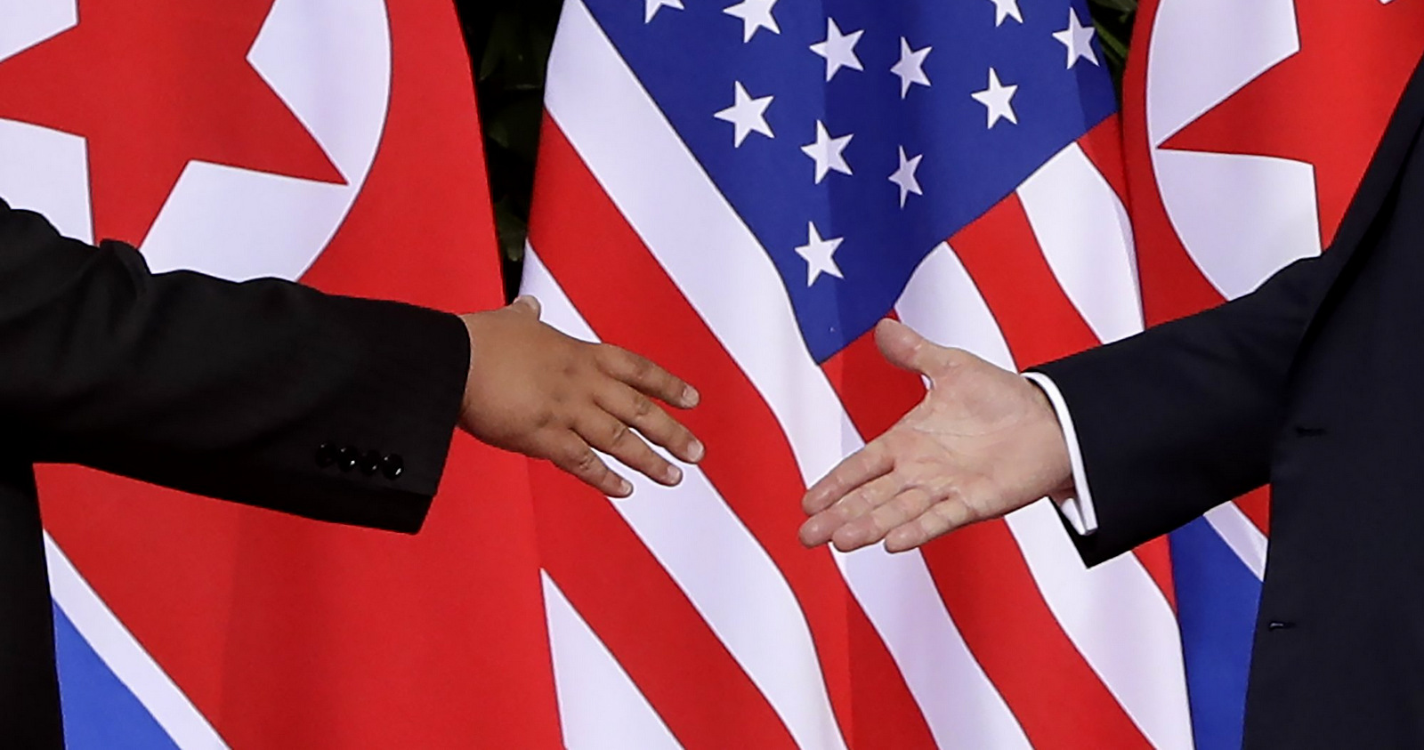 U.S. President Donald Trump, right, reaches to shakes hands with North Korea leader Kim Jong Un at the Capella resort on Sentosa Island, June 12, 2018 in Singapore. Evan Vucci | AP
