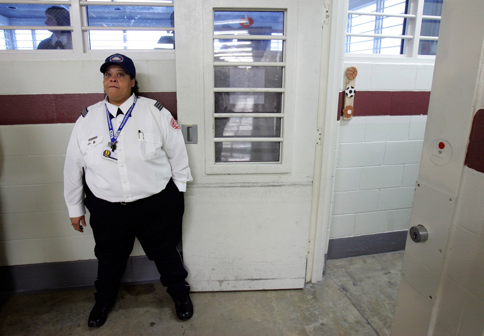 A guard holds open a door during a media tour of the T. Don Hutto Residential Center in Taylor, Texas, Friday, Feb. 9, 2007. LM Otero | AP