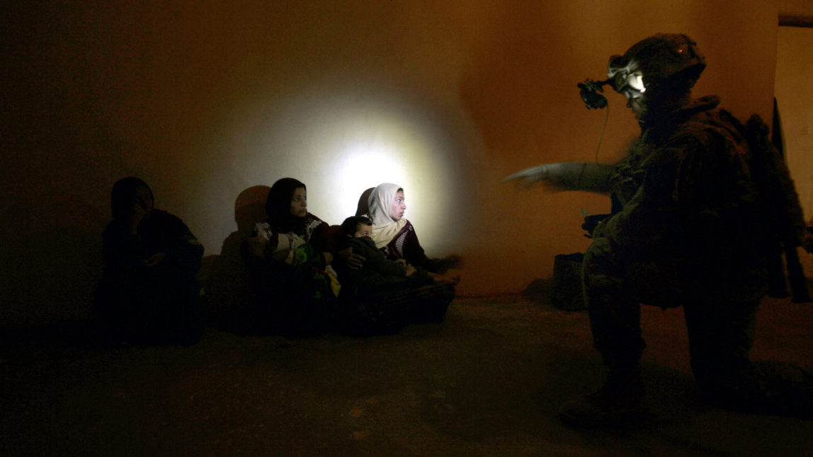 A U.S. army soldier from Blackfoot Company, 2nd Battalion, 23rd Infantry Regiment interrogates a Iraqis during an operation in the village of Walush in Diyala province, Iraq, Dec. 9, 2007. Marko Drobnjakovic | AP