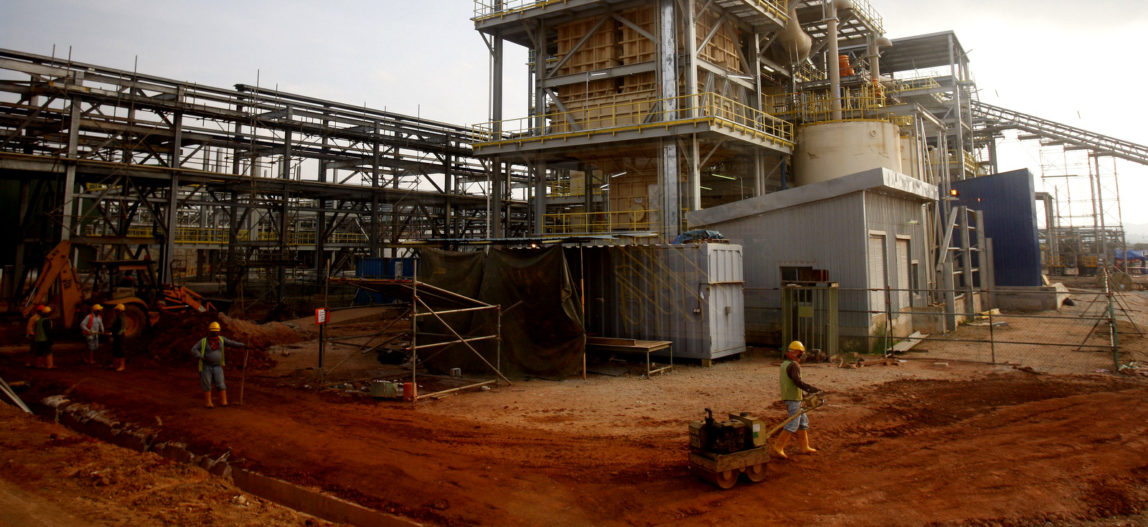 Workers walk and stand at the Lynas rare earth plant in Gebeng, eastern Malaysia, April 19, 2012. The minerals are crucial to high-tech manufacturing. Lai Seng Sin | AP