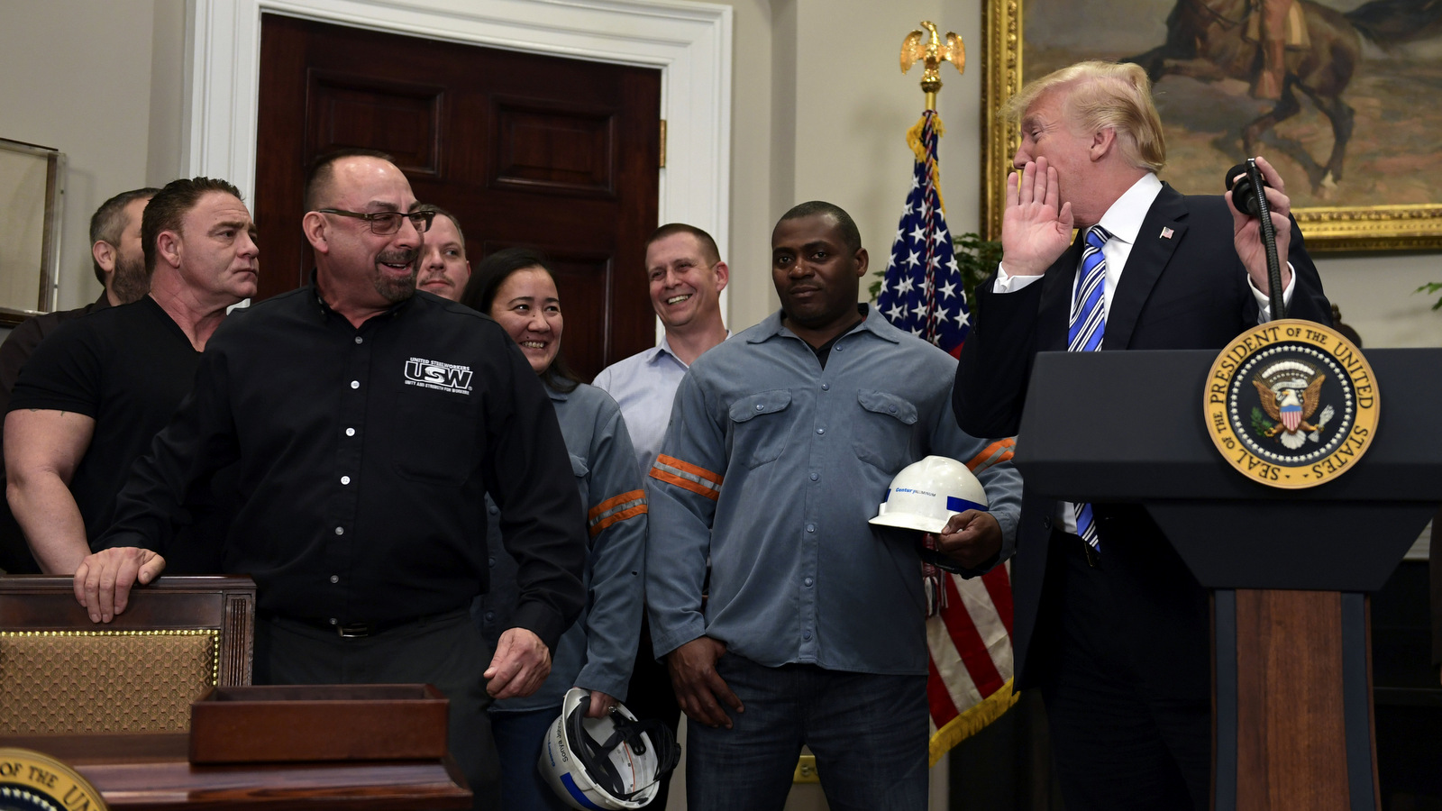 President Donald Trump, right, talks to Scott Sauritch, a maintenance worker at Irvin Works and President of Local 2227, during an event in the Roosevelt Room of the White House in Washington, Thursday, March 8, 2018. Trump signed two proclamations, one on steel imports and the other on aluminum imports. Susan Walsh | AP