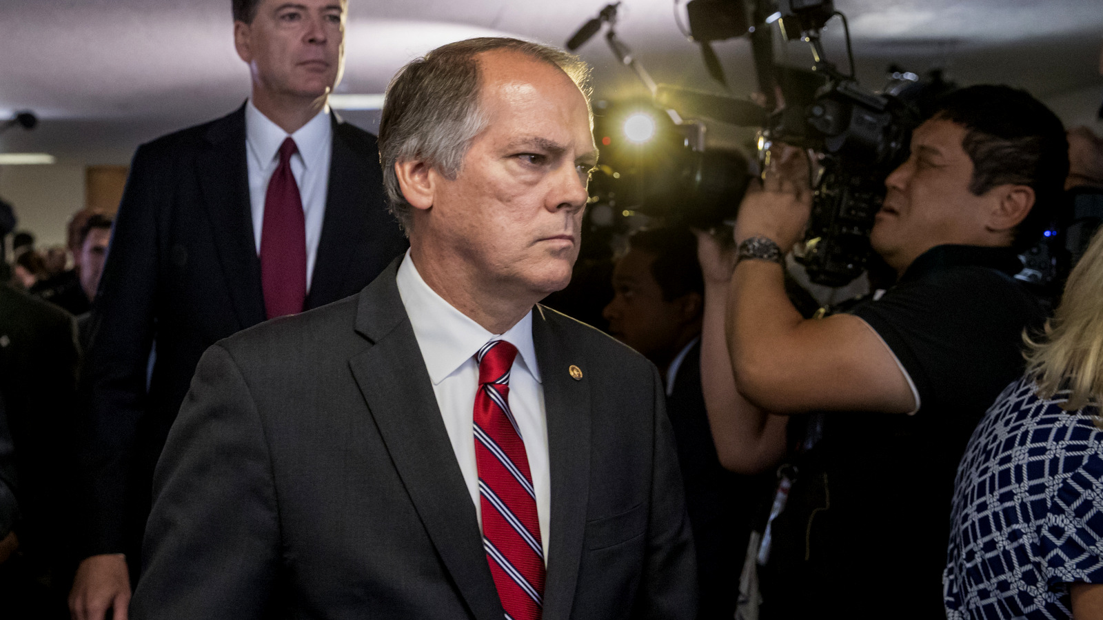 James Wolfe, center, former director of security with the Senate Intelligence Committee, escorts former FBI director James Comey to a secure room to continue his testimony on the 2016 election and his firing by President Donald Trump, on Capitol Hill in Washington,June 8, 2017. J. Scott Applewhite | AP