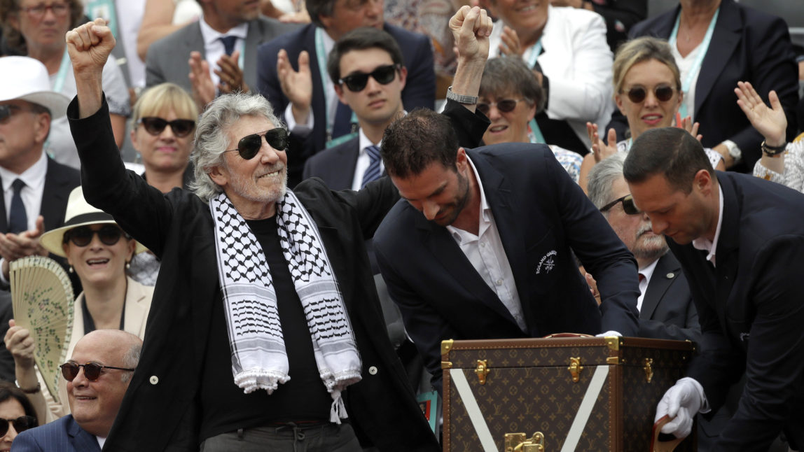 British musician and member of the Pink Floyd band Roger Waters presentS the trophy of the men's final match of the French Open tennis tournament at the Roland Garros stadium in Paris, France, June 10, 2018. Michel Euler | AP