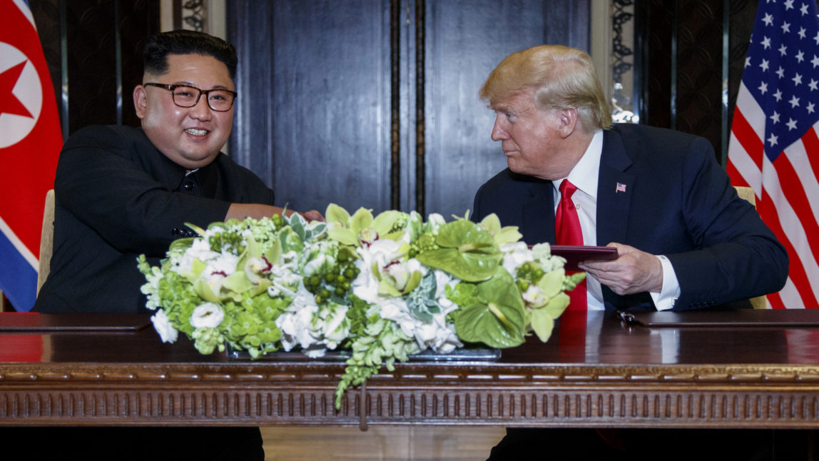 U.S. President Donald Trump looks at North Korea leader Kim Jong Un after their document singing at the Capella resort on Sentosa Island Tuesday, June 12, 2018 in Singapore. (AP Photo/Evan Vucci)