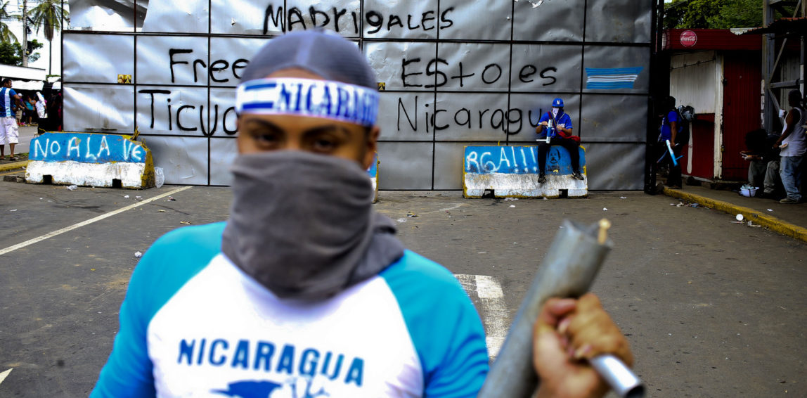 An anti-government protester poses for a picture holding a homemade mortar at a roadblock set up by protesters in Ticuantepe, Nicaragua, June 6, 2018. Esteban Felix | AP