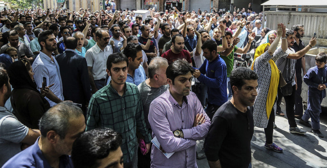 A group of protesters chant slogans at the old grand bazaar in Tehran, Iran, Monday, June 25, 2018. Protesters in the Iranian capital swarmed its historic Grand Bazaar on Monday, news agencies reported, and forced shopkeepers to close their stalls in apparent anger over the Islamic Republic's troubled economy, months after similar demonstrations rocked the country. (Iranian Labor News Agency via AP)