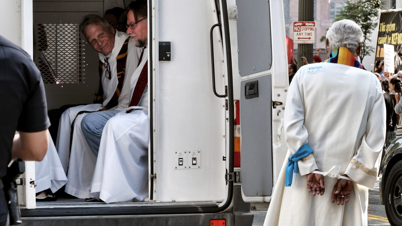 Clergy member are arrested and put into a police van after during a protest against Trump's immigration policies in front of Federal Courthouse in Los Angeles on June 26, 2018. Richard Vogel | AP