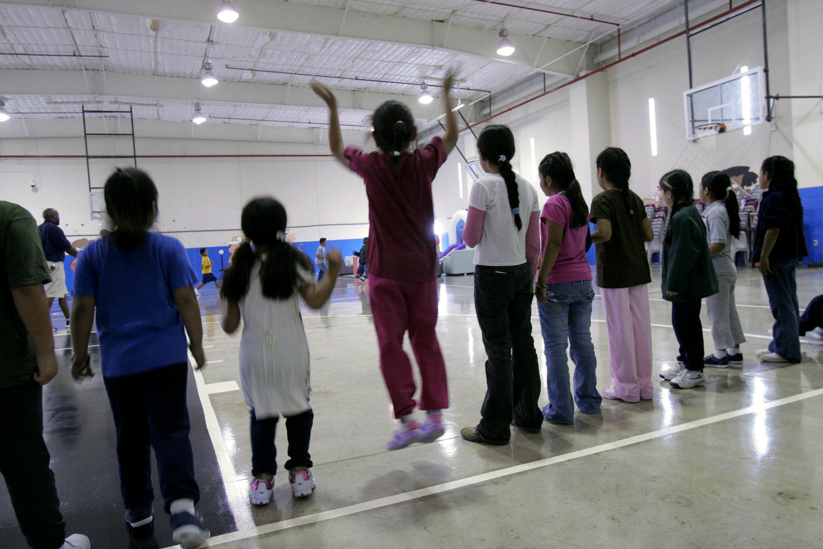 Children participate in physical education at the T. Don Hutto Residential Center in Taylor, Texas, during a tour for the media. Donna McWilliam | AP