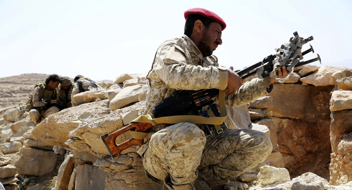 A Saudi-coalition soldier unslings his machine gun on the outskirts of Sanaa, Yemen, Feb. 2, 2018. Jon Gambrell | AP