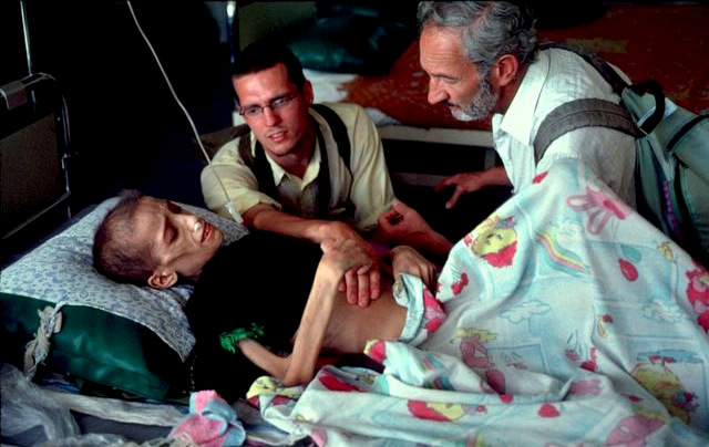 Bert Sacks, who smuggled medicine into Iraq, speaks to to a severely malnourished boy named Kamal, who died three days after this photo was taken. Photo | Alan Pogue
