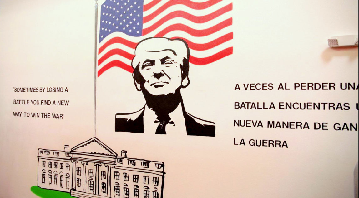 A mural at the Casa Padre migrant children’s shelter in Brownsville, Texas, with a quote – in English and Spanish – from Donald Trump’s 1987 book, The Art of the Deal. Source | Department of Health and Human Services