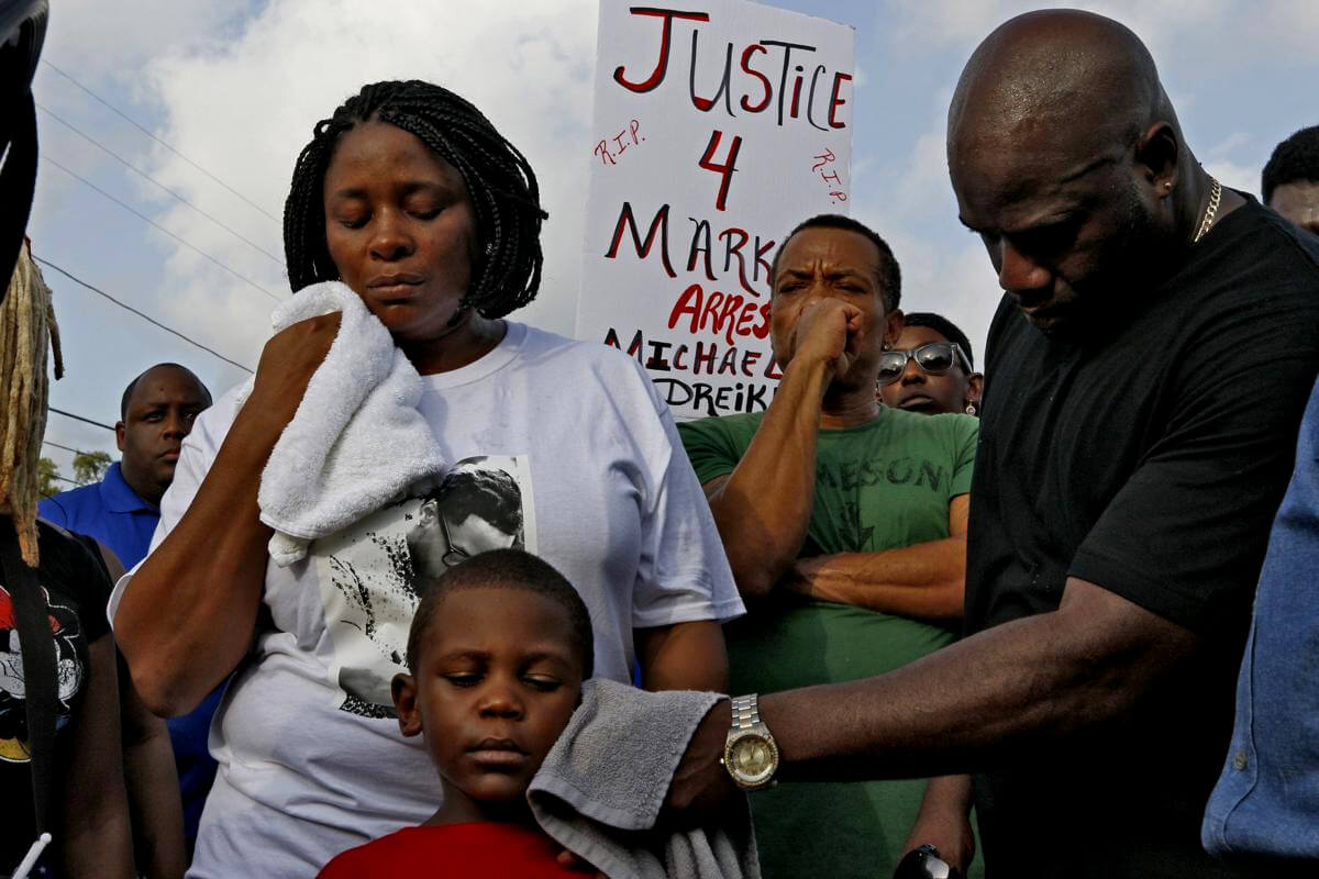 Michael McGlockton, the father of Markeis McGlockton, wipes the face of his grandson and five year-old-son of Markeis, Markeis McGlockton Jr., as protesters gathered to voice their concerns in Clearwater Fla., July 22, 2018. Luis Santana |  Tampa Bay Times via AP