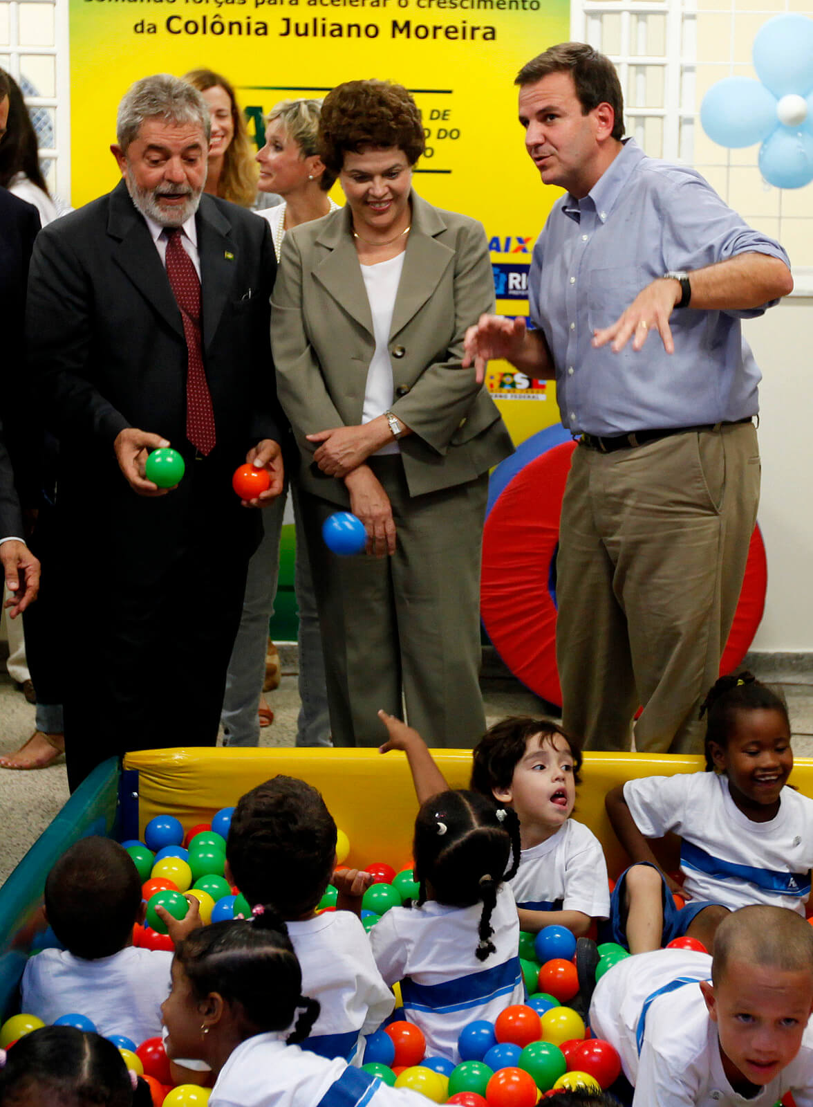 Brazil's President Lula da Silvia, left, chief of Staff Dilma Rousseff, center, and Rio's Mayor Eduardo Paes, play with kids before Lula inaugurated a project as part of a Growth Acceleration Program in Rio de Janeiro, Jan. 25, 2010. Felipe Dana | AP