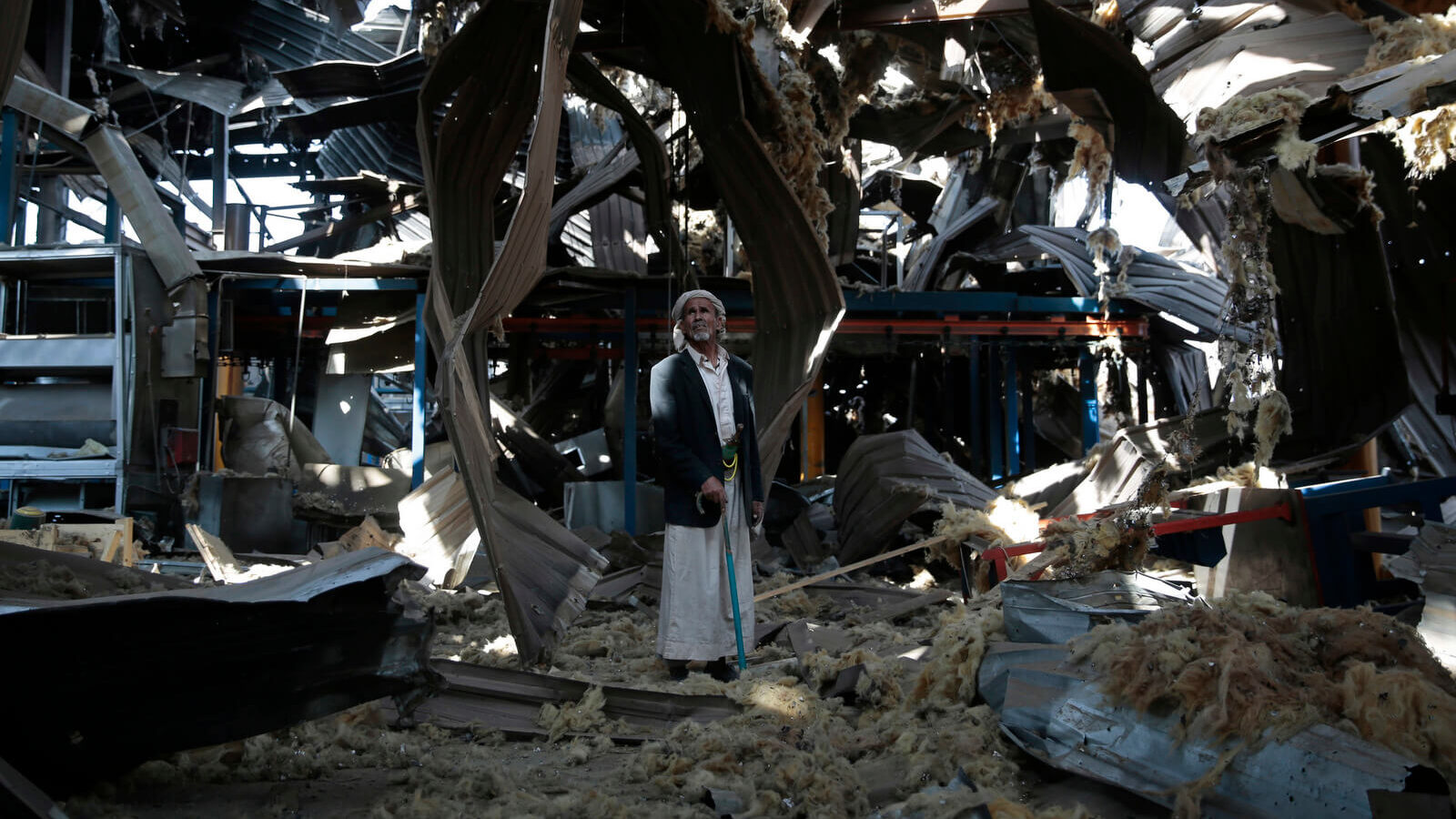 An elderly man stands among the rubble of the Alsonidar Group's water pump and pipe factory after it was hit by Saudi-led airstrikes in Sanaa, Yemen, Sept. 22, 2016. Hani Mohammed | AP
