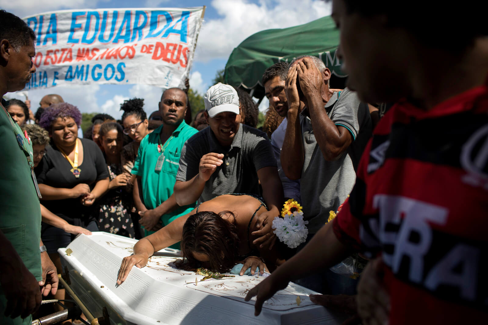 Relatives express their grief during the burial of 13-year-old Maria Eduarda Alves da Conceicao in Rio de Janeiro, Brazil, March 1, 2017. Leo Correa | AP