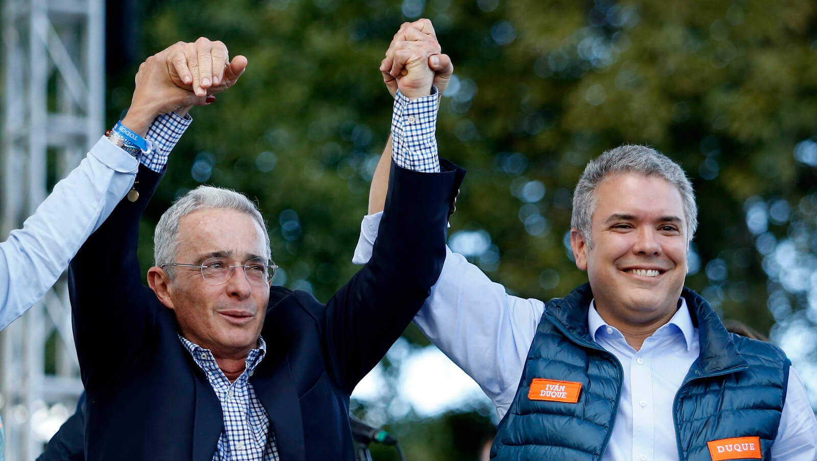 Ivan Duque and former President Alvaro Uribe raise their hands during a campaign rally in Bogota, Colombia, May 20, 2018. Fernando Vergara | AP