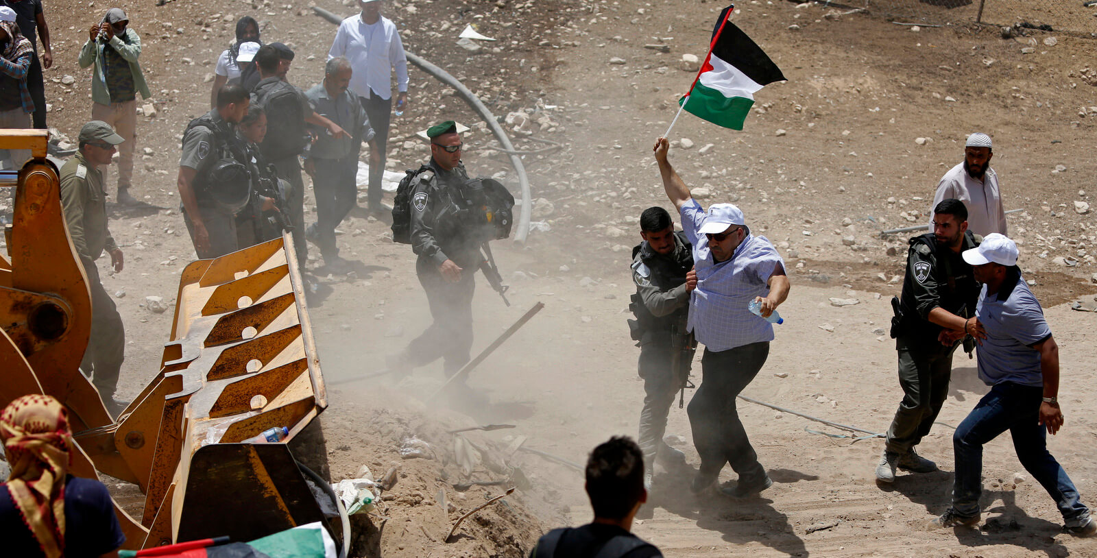 Israeli police push Palestinians protesting the planned demolition of their West Bank village of Khan al-Ahmar, July 4, 2018. Majdi Mohammed | AP