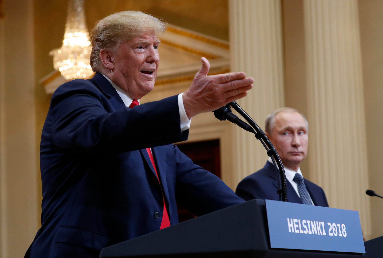 U.S. President Donald Trump, left, gestures while speaking as Russian President Vladimir Putin, right, looks on during their joint news conference at the Presidential Palace in Helsinki, Finland, July 16, 2018. Pablo Martinez Monsivais | AP