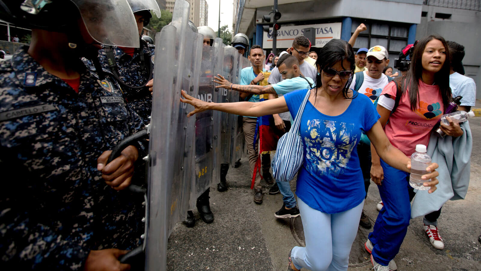 Demonstrators push police's shields as they protest Venezuela's President Nicolas Maduro near the attorney generals office in Caracas, Venezuela, July 18, 2018. The previous night, former presidential candidate and opposition leader Henrique Capriles called on the country's political forces to reorganize in order to cope with the South American country's hyperinflation, and lack of food and medicine. Fernando Llano | AP