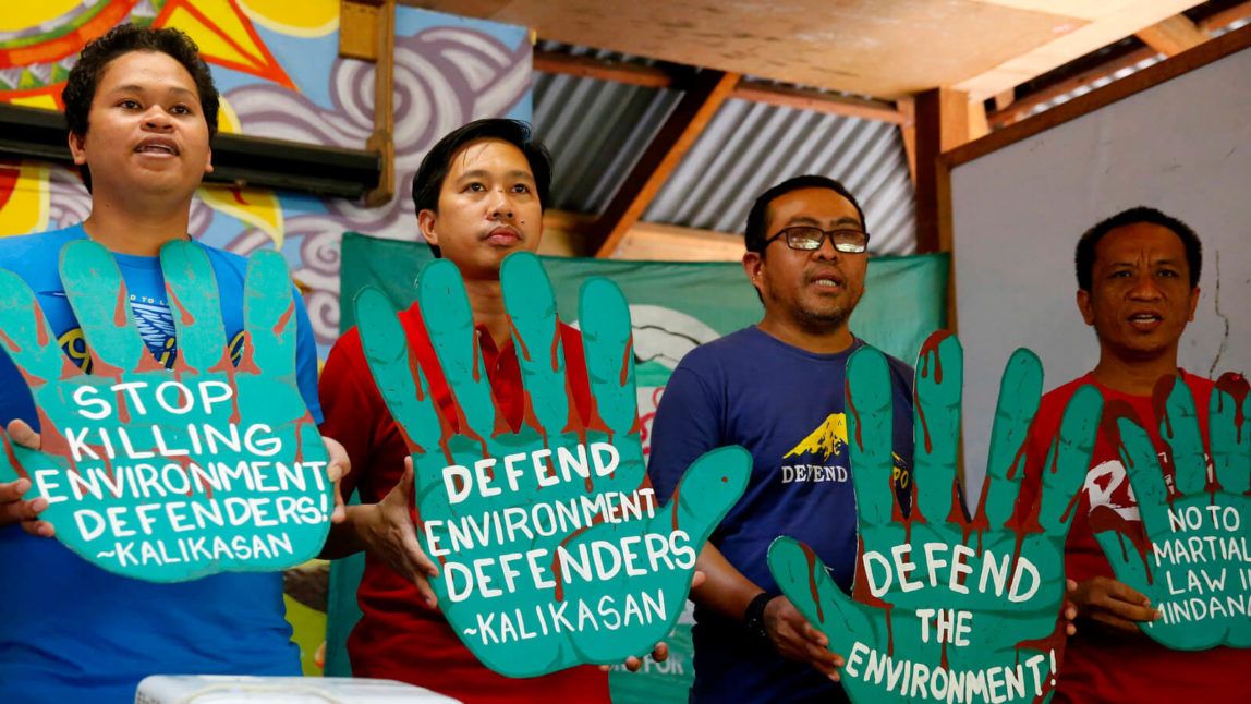 Activists in Quezon city protest President Rodrigo Duterte's militarized push for big mining firms and plantations making 2017 the bloodiest year for environmental defenders." Bullit Marquez | AP