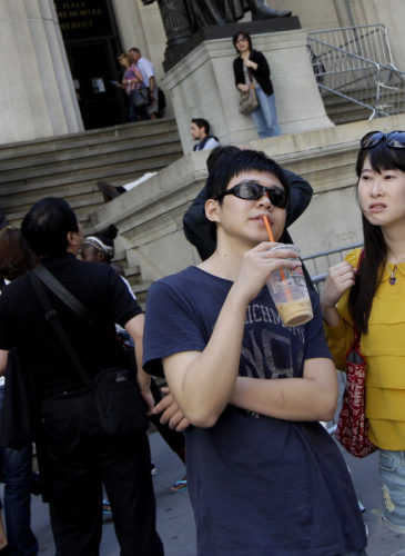 Tourists from China take in the sights of the New York Stock Exchange and Federal Hall National Memorial, in New York. Chinese tourists are among the fastest-growing and highest-spending groups of international visitors to the United States. Mary Altaffer | AP