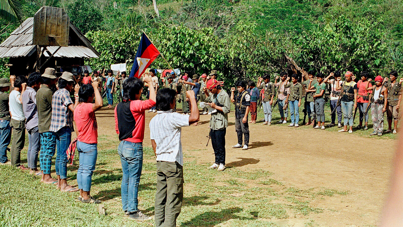 Communist New Peoples Army guerrilla recruits, foreground, take an oath of loyalty before a company-sized guerrilla force, Feb. 13, 1987 in the jungles of Agusan, southern Philippines. Alberto Marquez | AP