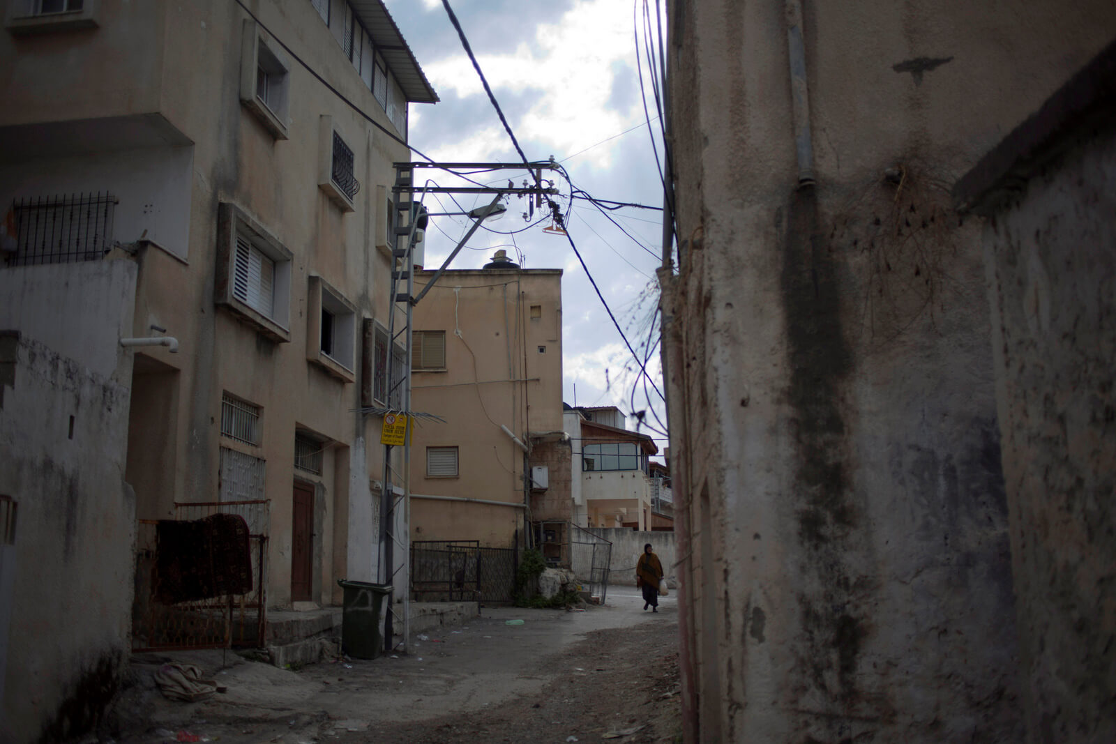 An Israeli Arab woman walks in the Arab town of Taybeh, central Israel wants to move large chunks of Israeli Arabs into Palestine, reminding Arabs of their second-class status in the Jewish state. Ariel Schalit | AP