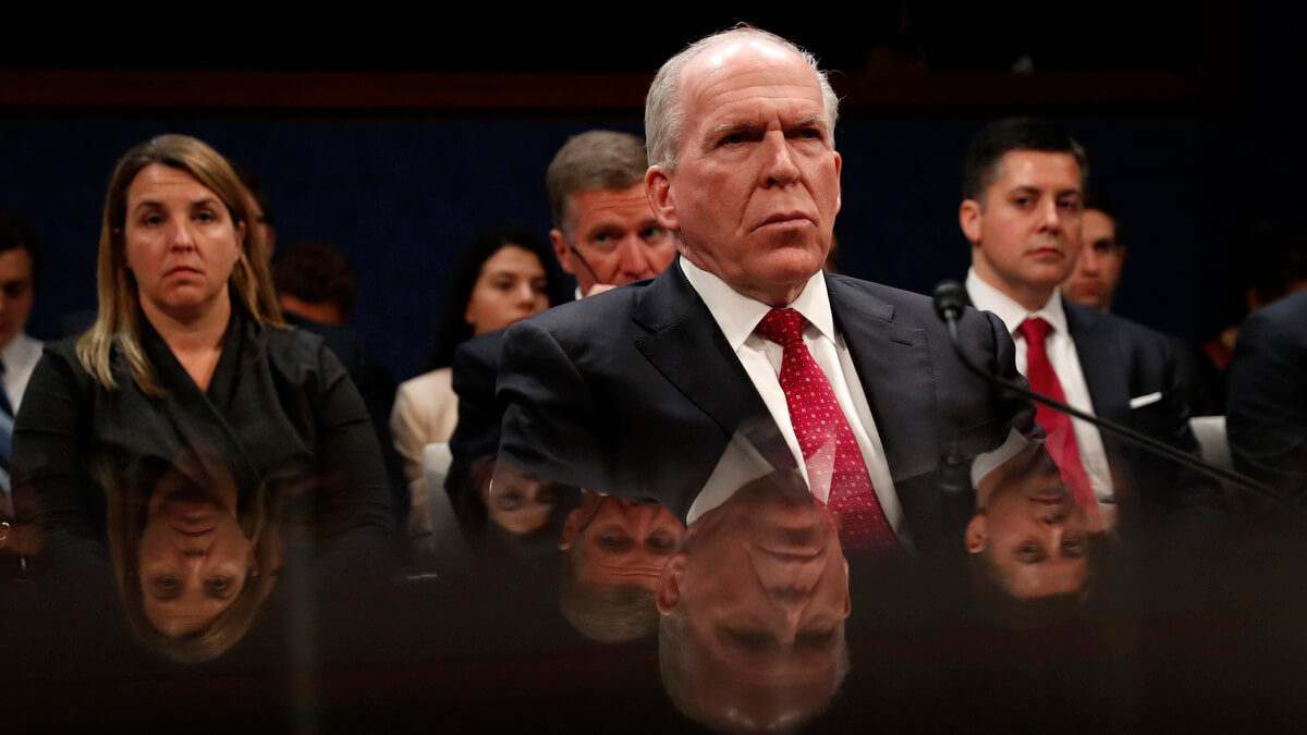 Former CIA Director John Brennan is reflected in a table as he prepares to testify on CapitolHill in Washington, May 23, 2017, before the House Intelligence Committee Russia Investigation Task Force. Pablo Martinez Monsivais | AP