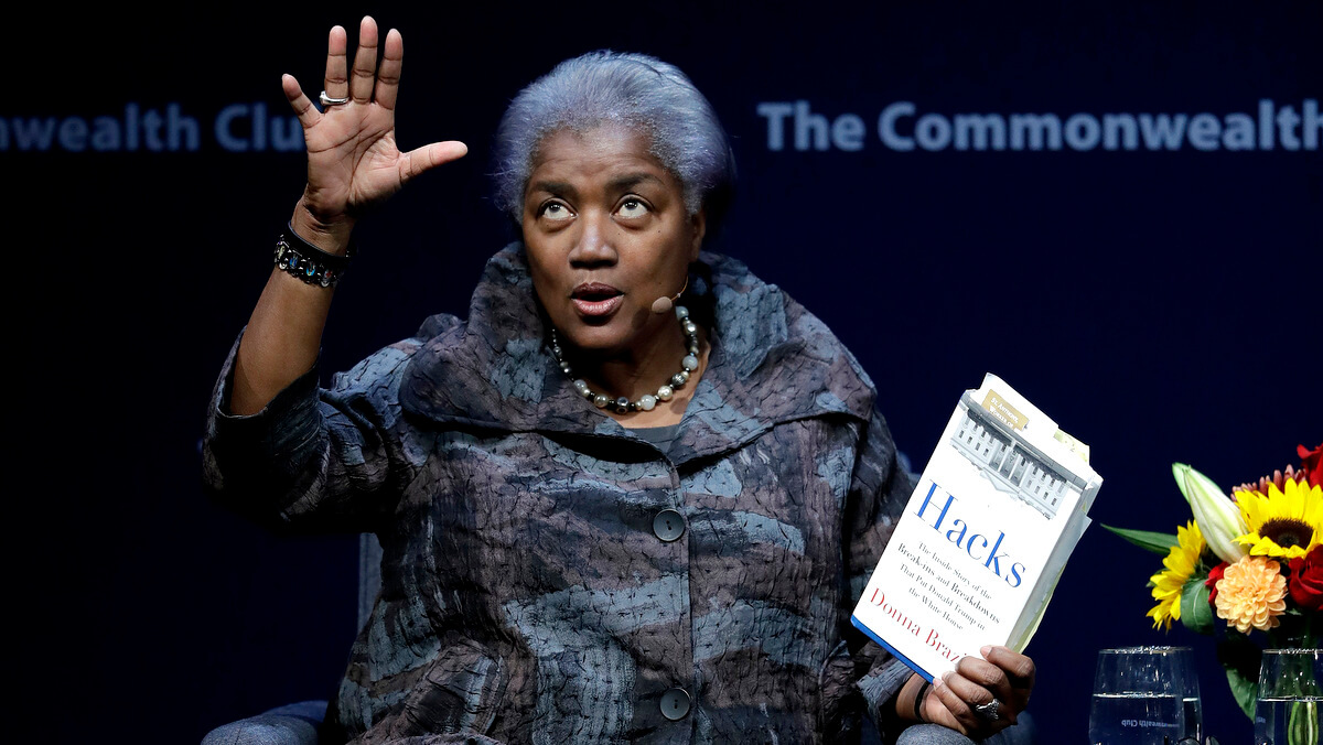 Former Democratic National Committee chair Donna Brazile holds a copy of her book Hacks, detailing the hacking of the DNC, during a meeting of The Commonwealth Club, Nov. 9, 2017, in San Francisco. Marcio Jose Sanchez | AP