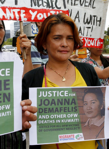 Protesters picket the Senate at the start of the probe in the death of an overseas worker in Kuwait, Pasay city south of Manila, Philippines