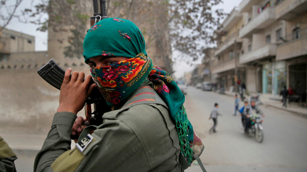 A member of the Kurdish internal security forces holds his weapon during a patrol in Manbij, north Syria. Hussein Malla | AP