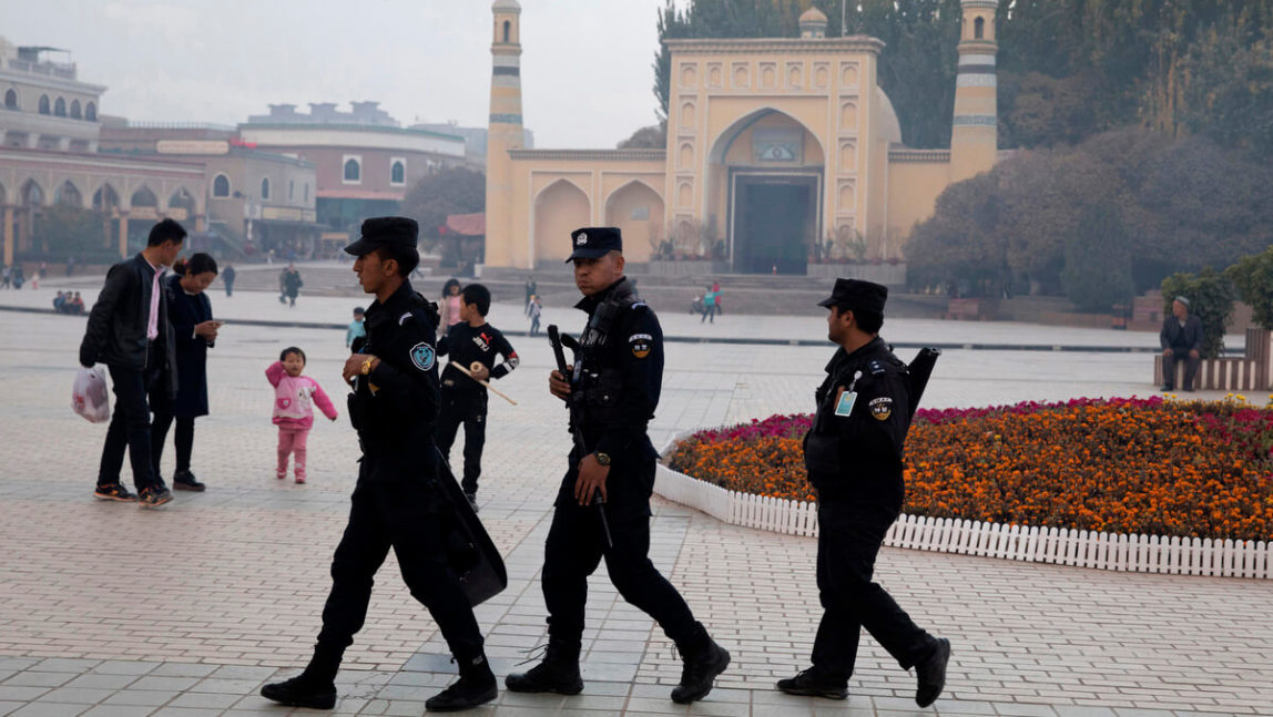 In this Nov. 4, 2017 file photo, Uighur security personnel patrol near the Id Kah Mosque in Kashgar in western China's Xinjiang region. Ng Han Guan | AP