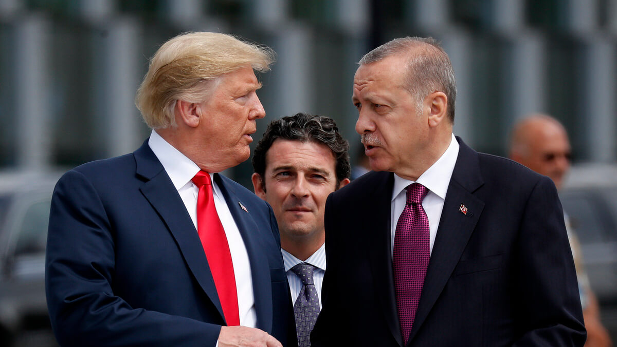 President Donald Trump, left, talks with Turkey's President Recep Tayyip Erdogan, right, as they arrive together for a family photo at a summit of heads of state and government at NATO headquarters in Brussels on July 11, 2018. Pablo Martinez Monsivais | AP