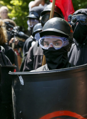 Counter-protesters prepare to clash with Patriot Prayer protesters during a rally in Portland, Ore., Aug. 4, 2018. Small scuffles broke out Saturday as police in Portland, Oregon, deployed "flash bang" devices and other means to disperse hundreds of right-wing and self-described anti-fascist protesters. John Rudoff | AP