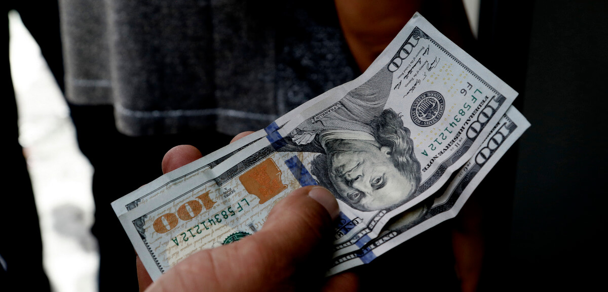 A Turkish waits to change his US dollars with Turkish liras inside a currency exchange shop in Ankara, Turkey, Aug. 10, 2018. Burhan Ozbilici | AP