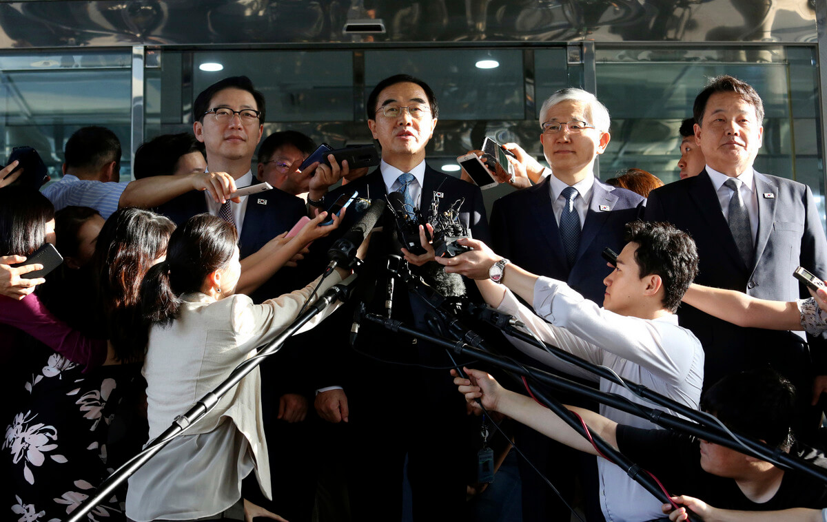South Korean Unification Minister Cho Myoung-gyon, center, speaks to the media before leaving for the border village of Panmunjom to attend a meeting between South and North Korea, Aug. 13, 2018. Ahn Young-joon | AP