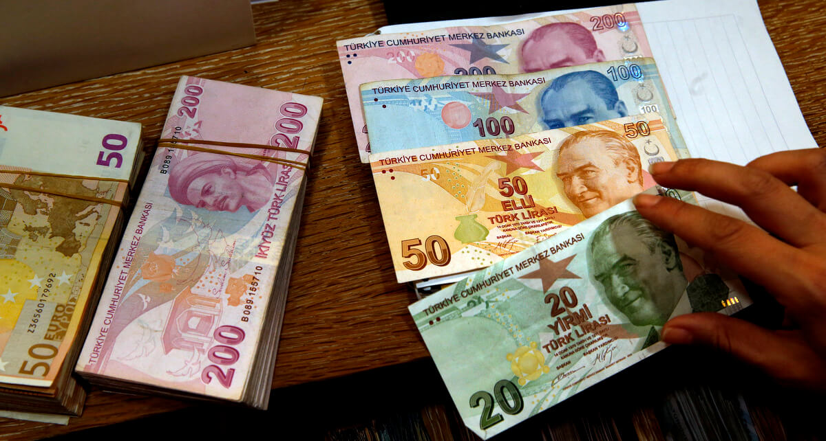 A worker at a currency exchange shop worker lays out Turkish lira banknotes depicting modern Turkey's founder Mustafa Kemal Ataturk, in Istanbul, Aug. 15, 2018. Lefteris Pitarakis | AP