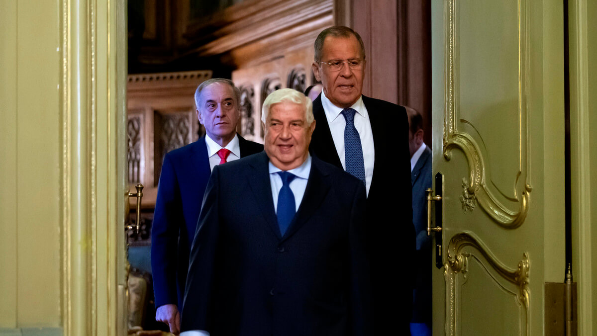 Syrian Foreign Minister Walid Muallem, center, and Russian Foreign Minister Sergey Lavrov, right, enter a hall for their joint news conference followed their talks in Moscow, Russia, Aug. 30, 2018. Alexander Zemlianichenko | AP