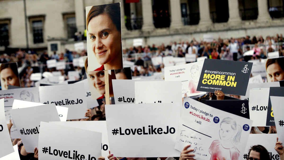 People hold signs during a Jo Cox memorial in Trafalgar Square, London, June 22, 2016. Alastair Grant | AP