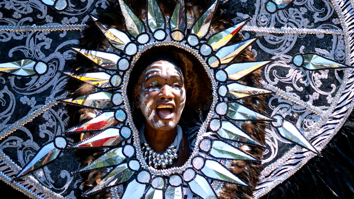A person participates in the West Indian American Day Parade in Brooklyn New York, Sept. 3, 2018. New York's Caribbean community has held annual Carnival celebrations since the 1920s, first in Harlem and then in Brooklyn, where festivities happen on Labor Day. Craig Ruttle | AP