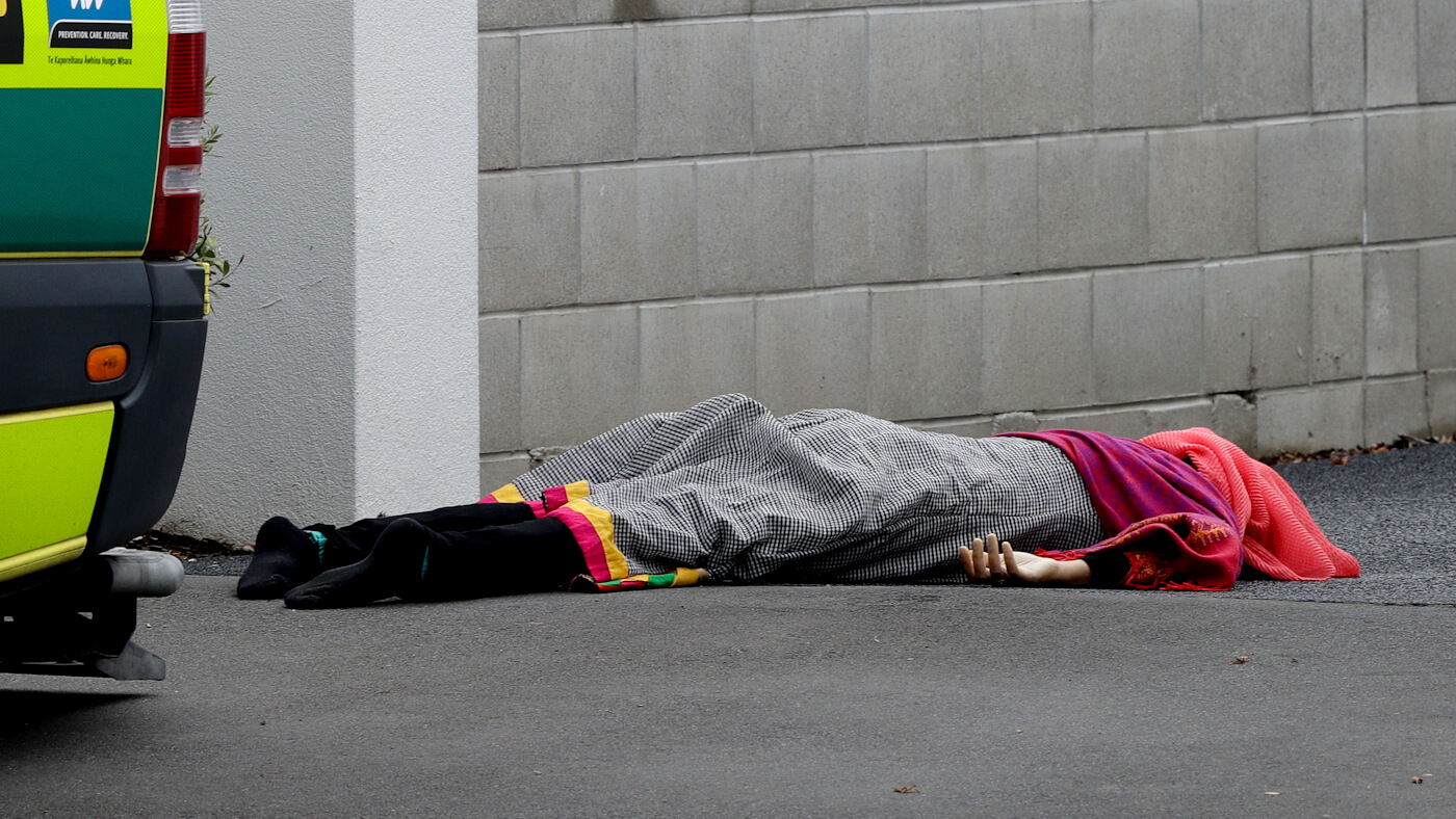 A body lies on the footpath outside a mosque in central Christchurch, New Zealand, March 15, 2019, following a mass shooting. Mark Baker | AP